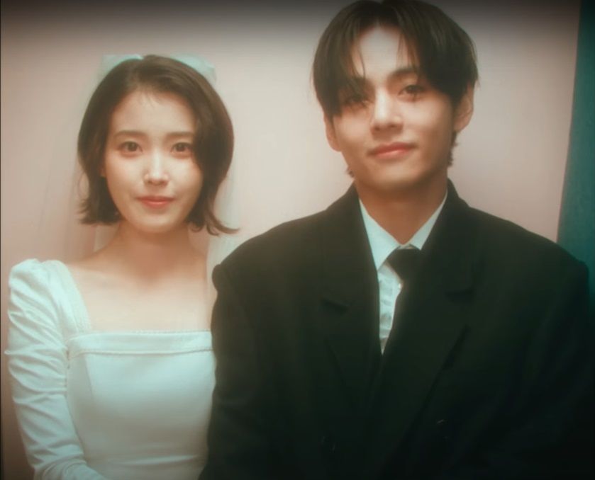 Makna lirik lagu Love Wins All dari IU dengan V BTS sebagai model video musik, sepasang kekasih saling bertahan di tengah tantangan akan hubungan.